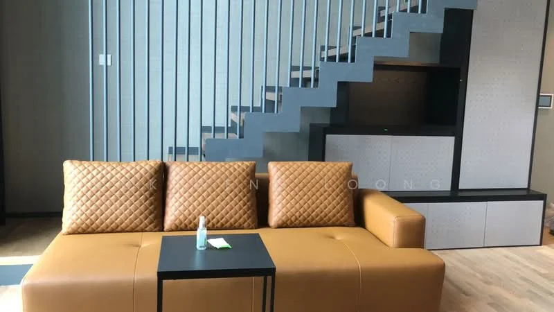 Living features: brown leather sectional sofa, black coffee table, wooden flooring, staircase with grey steps, feature wall with vertical slats, built-in cabinetry, wall-mounted TV unit, neutral wall color; style: modern.