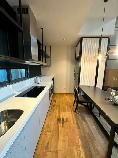 Kitchen features: single-bowl stainless-steel sink, chrome pull-down faucet, white cabinetry with perforated design, black countertop, built-in oven, freestanding range oven, microwave, open shelving, wooden flooring, recessed downlights, pendant lighting, dining table, black dining chair; style: modern.