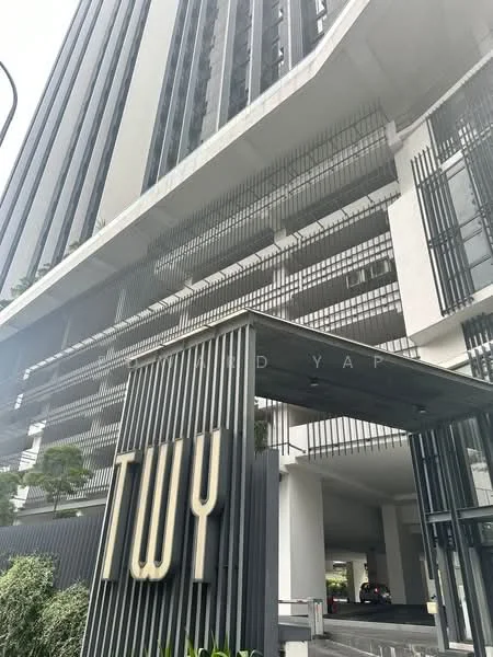 Exterior type: high-rise condominium; features: glass curtain wall, vertical fins, projecting balconies, modern facade with dark accents, entrance with signage, landscaped entrance area, parking area visible, multiple storeys, surrounded by greenery; style: modern.