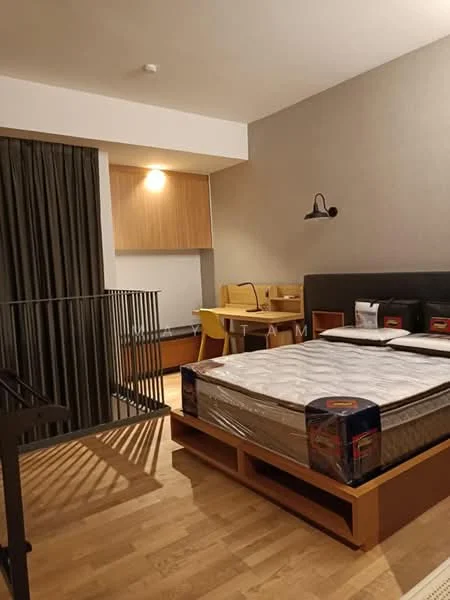 Bedroom features: queen-size bed, wooden bed frame, wooden flooring, grey accent wall, wall-mounted reading light, built-in wardrobe, desk with two chairs, curtains, decorative wall shelf, open railing, light fixture on ceiling; style: modern.