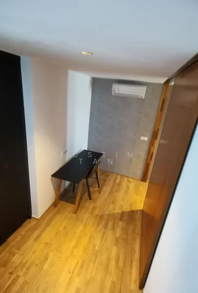 Room features: wooden flooring, white painted walls, grey accent wall, wall-mounted split AC, ceiling lights, black table, wooden door, built-in wardrobe; style: modern.