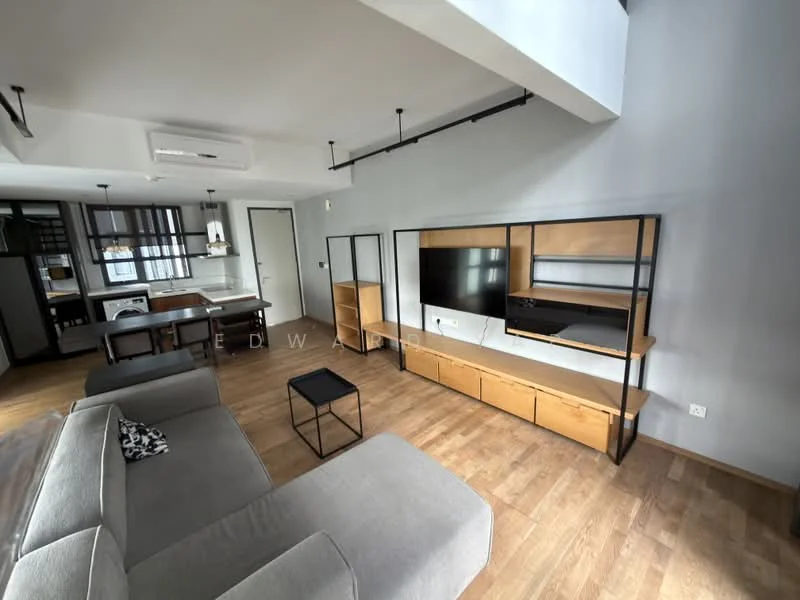 Living features: grey fabric sofa, black coffee table, wooden TV console, wall-mounted TV, open shelving unit, wooden flooring, recessed downlights, wall-mounted split AC, large windows, neutral wall color; style: modern. Kitchen features: dining table, black dining chairs, open kitchen layout, kitchen cabinetry, appliances visible; style: modern.