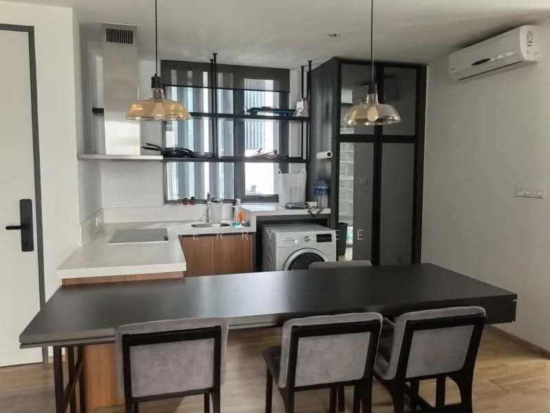 Kitchen features: white quartz countertop, stainless-steel sink, chrome pull-down faucet, built-in oven, freestanding washing machine, white cabinetry, black-framed glass partition, 2-blade ceiling fan, recessed downlights, wooden flooring, 4-seater dining table, pendant lighting; style: modern.