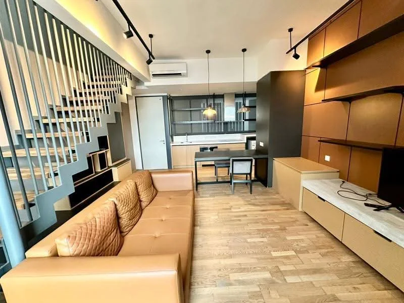 Living features: 3-seater leather sofa in tan, wooden flooring, wall-mounted TV, TV console with storage, built-in shelving unit, desk with chair, pendant lighting, air conditioning unit, staircase with metal railing, large window, decorative wall paneling; style: modern.