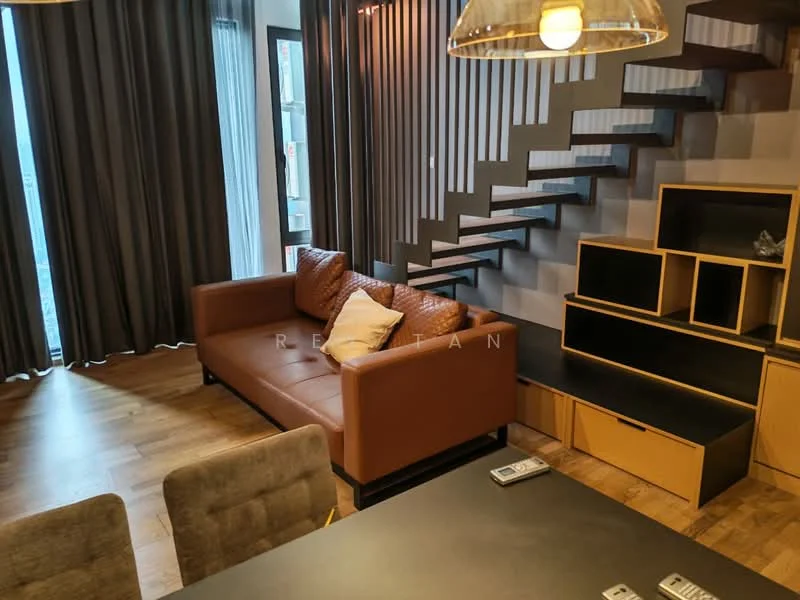 Living features: brown leather sofa, wooden flooring, large windows with sheer curtains, open staircase with wooden steps, black TV console, wooden shelving unit, decorative cushions, pendant lighting; style: modern; view: city.