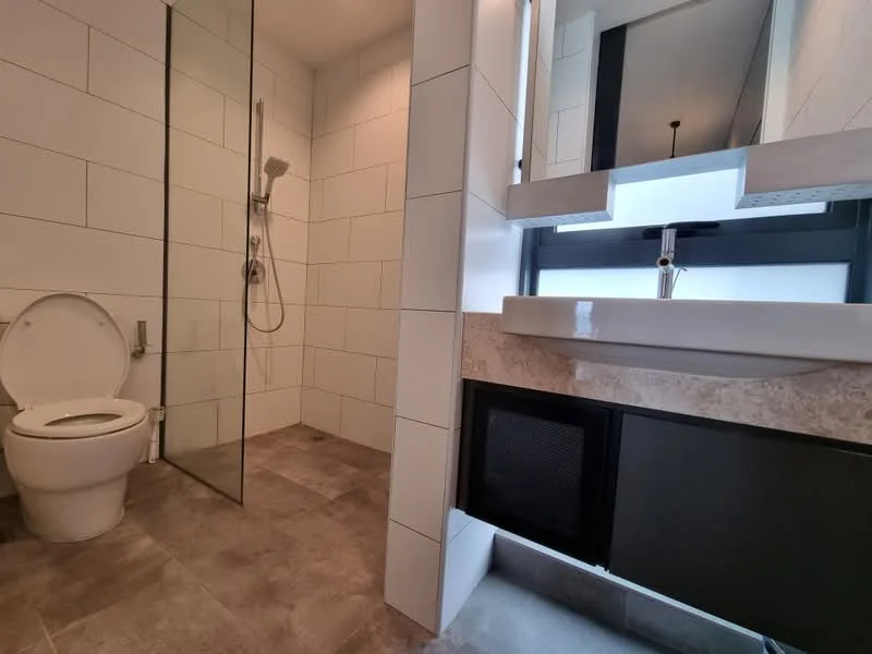 Bathroom features: walk-in shower with glass enclosure, rain shower head, handheld shower, single-sink vanity with stone countertop, chrome basin mixer, framed mirror, one-piece toilet, grey ceramic tile flooring, white tiled walls, black cabinetry under sink, recessed lighting; style: modern.