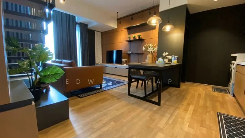 Living features: wooden flooring, brown leather sofa, black coffee table, TV console, wall-mounted TV, decorative plants, area rug with geometric pattern, pendant lighting, black accent wall, large windows with curtains, open layout to dining area; style: modern. Dining features: dining table with black frame, 4 dining chairs, decorative vase on table; style: modern.