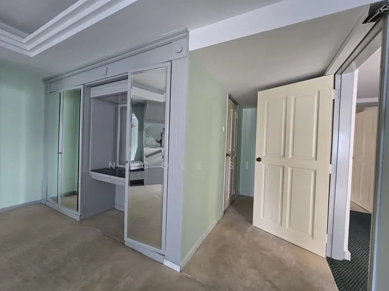 Room features: light green painted walls, grey trim around walls, mirrored sliding wardrobe doors, plain ceiling with crown moulding, concrete flooring, white door with panel design, doorway leading to another room; style: modern.