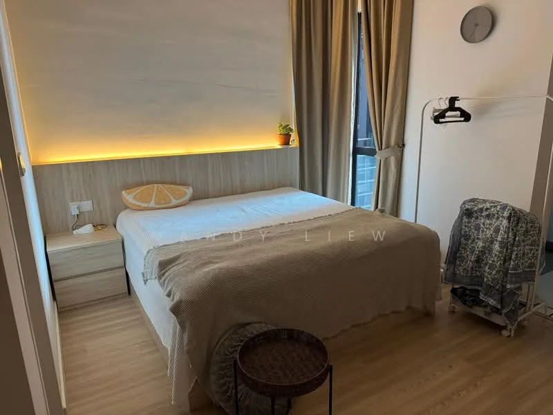 Bedroom features: queen-size bed with beige bedding, wooden bed frame, wooden bedside table, wall-mounted light fixture, decorative wall art, curtains in beige, wooden flooring, plant on bedside table, clock on wall, clothes rack, woven stool; style: modern.