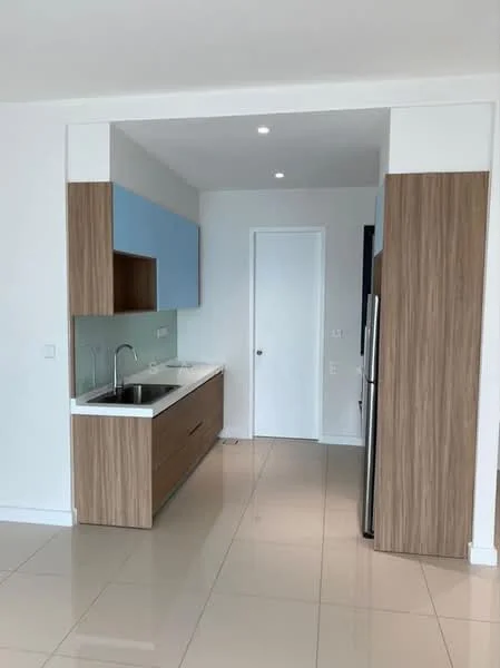 Kitchen features: white countertop, single-bowl stainless-steel sink, chrome pull-down faucet, wood cabinetry with light wood finish, blue upper cabinets, stainless-steel fridge, ceramic tile flooring, recessed downlights, plain white walls, door leading to another room; style: modern.