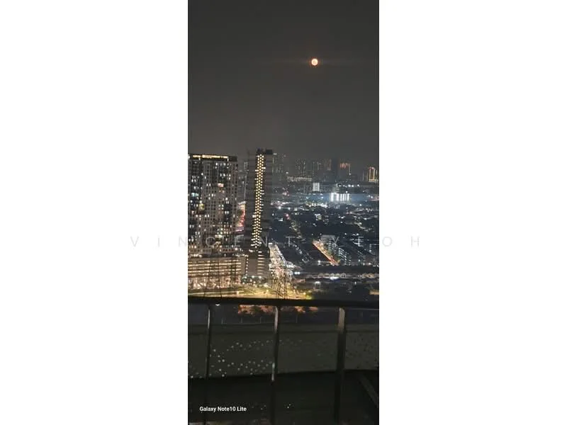Exterior type: high-rise condominium; features: city skyline view, night lighting, balcony railing, surrounding high-rise buildings, moon visible in the sky; style: modern.