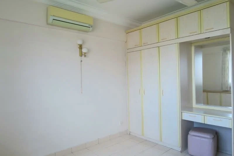 Bedroom features: cream painted walls, tile flooring, built-in wardrobe with yellow accents, mirror with dressing table, 1 wall-mounted split AC, wall sconce lighting, curtains, neutral decor.