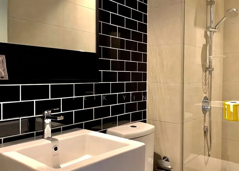 Bathroom features: black glossy tile walls, cream tiled walls, glass shower enclosure, chrome shower head, chrome handheld shower, white square sink, chrome basin mixer faucet, one-piece toilet, mirror above sink, yellow toilet paper holder; style: modern.