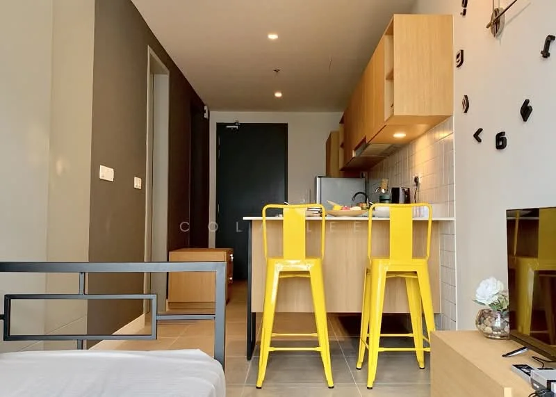 Kitchen features: yellow bar stools, wooden cabinetry, white tiled backsplash, countertop with overhang, stainless-steel fridge, built-in oven, sink, kitchen island, recessed lighting, grey accent wall, floor tiles, open layout; style: modern. Room features: bed frame, wall-mounted TV, wooden storage unit.