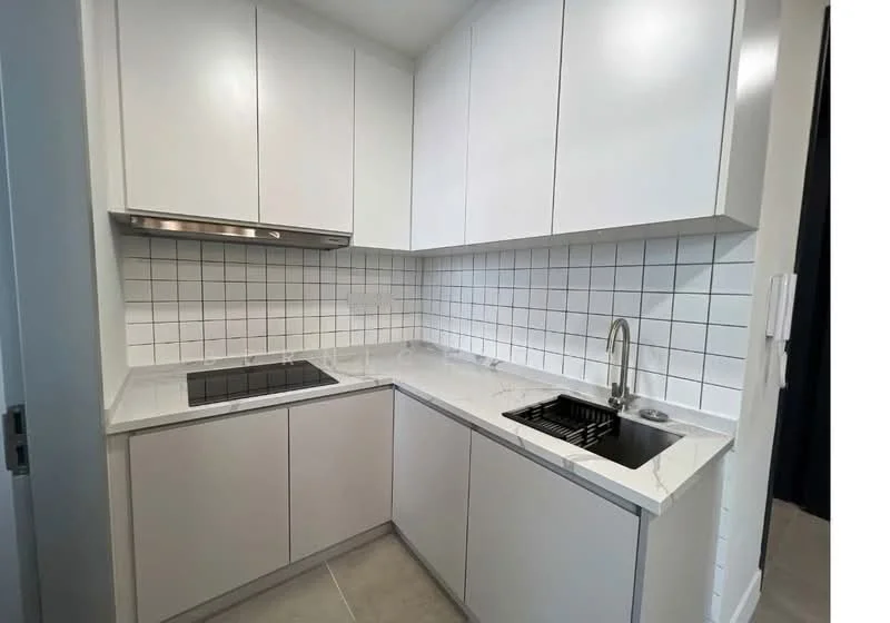 Kitchen features: white flat-panel cabinets, marble countertop, stainless-steel sink, chrome pull-down faucet, built-in oven, 4-burner gas hob, white tiled backsplash, grey tile flooring, under-cabinet lighting, ventilation hood; style: modern.