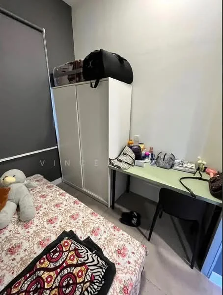 Bedroom features: single bed with floral bedding, white wardrobe, green study desk, black chair, decorative throw pillows, stuffed animal on bed, cosmetics and personal items on desk, grey walls, laminate flooring; style: modern.