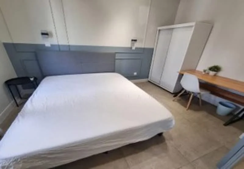 Bedroom features: queen-size bed with white bedding, grey accent wall, white painted walls, tile flooring, built-in wardrobe, study desk with wooden top, white chair, nightstand, wall-mounted reading lights; style: modern.