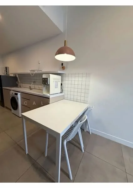 Kitchen features: white painted walls, grey tiled flooring, white countertop, single-bowl stainless-steel sink, chrome pull-down faucet, built-in microwave, front-load washing machine, white cabinetry, pendant light, small dining table, plastic dining chairs; style: modern.