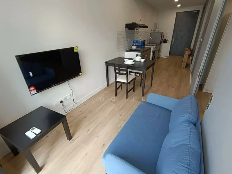 Living features: blue fabric sofa, black coffee table, wall-mounted TV, light wood flooring, dining table with two chairs, kitchenette in background, white tiled backsplash, refrigerator, microwave, kitchen cabinets, countertop, open layout; style: modern.