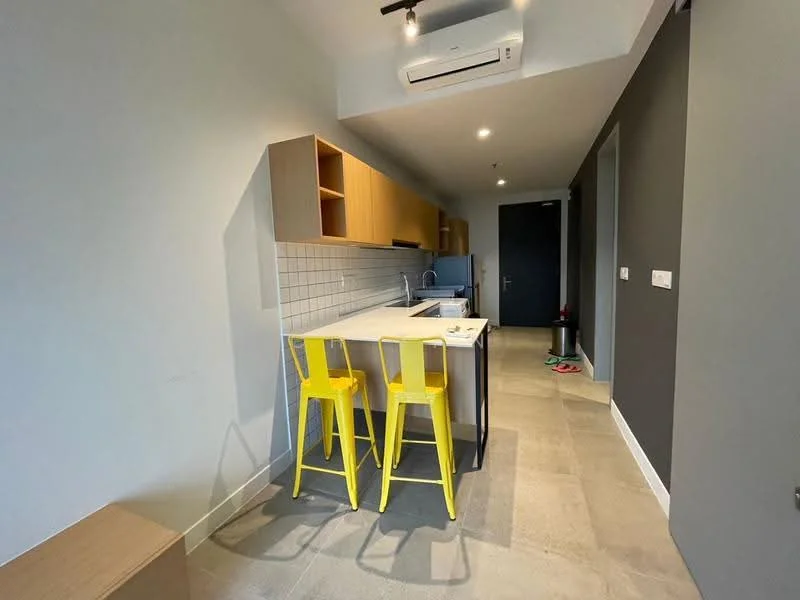 Kitchen features: light grey walls, dark grey accent wall, tile flooring, wood cabinetry, white tiled backsplash, stainless-steel sink, chrome pull-down faucet, kitchen island with seating, two yellow bar stools, recessed downlights, wall-mounted split AC; style: modern.