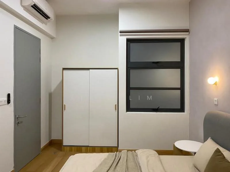 Bedroom features: queen-size bed with beige bedding, light grey upholstered headboard, wooden bedside table, white built-in wardrobe with sliding doors, floor-to-ceiling window with black frame, light fixture on wall, wooden flooring, wall-mounted air conditioning unit; style: modern.