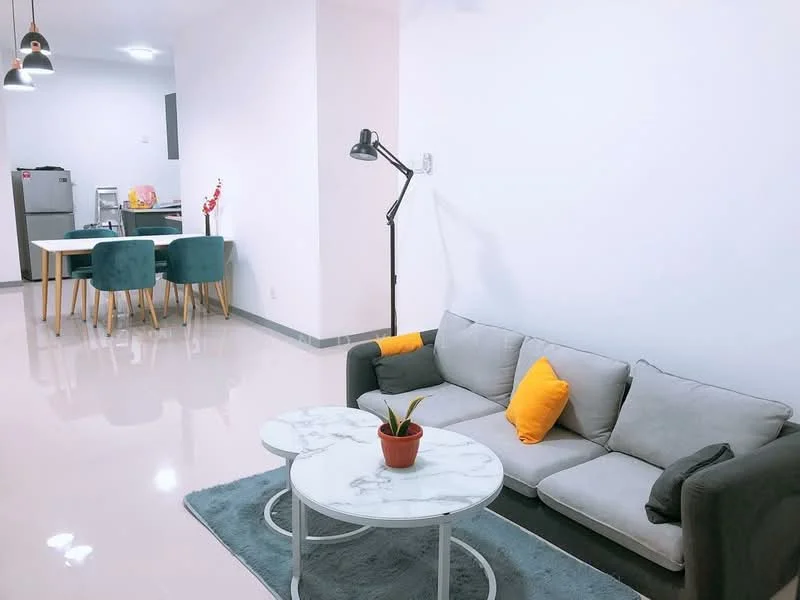 Living features: grey fabric sofa, yellow accent cushions, white marble coffee table, blue area rug, floor lamp, recessed ceiling lights, glossy tile flooring, white painted walls; style: modern. Dining features: round dining table, blue upholstered dining chairs, stainless-steel fridge, open kitchen area; style: modern.