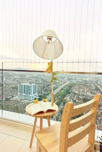 Balcony features: glass railing, floor tiles, outdoor lamp with shade, wooden chair, small round table, decorative items on table, city view, potted plant; style: modern; view: city.