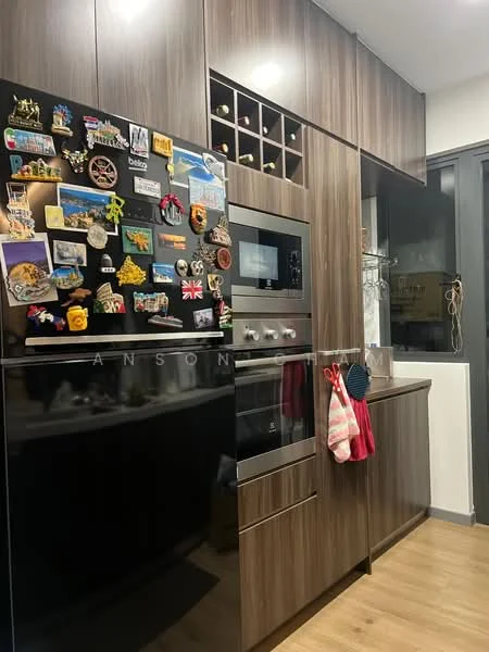 Kitchen features: dark wood cabinetry, built-in oven, stainless-steel microwave, black glass front refrigerator, wine rack above counter, magnetic fridge door with various magnets, countertop with space for appliances, wooden flooring, hanging dish towels; style: modern.