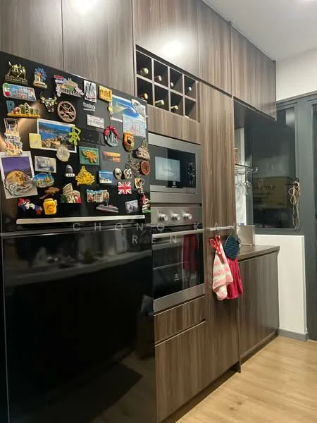 Kitchen features: dark wood cabinetry, black refrigerator, built-in oven, wine rack above oven, magnetic fridge decorations, countertop, kitchen towels hanging, light wood flooring; style: modern.