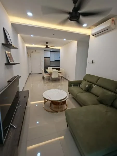 Living features: green fabric L-shape sectional sofa, round coffee table with wooden base, wall-mounted TV, TV console with storage, recessed LED downlights, ceiling fan, white painted walls, glossy tile flooring, air conditioning unit, open layout to kitchen, decorative wall shelf; style: modern. Kitchen features: stainless-steel fridge, built-in oven, 4-burner gas hob, kitchen cabinets with flat-panel design, countertop with space for appliances; style: modern.