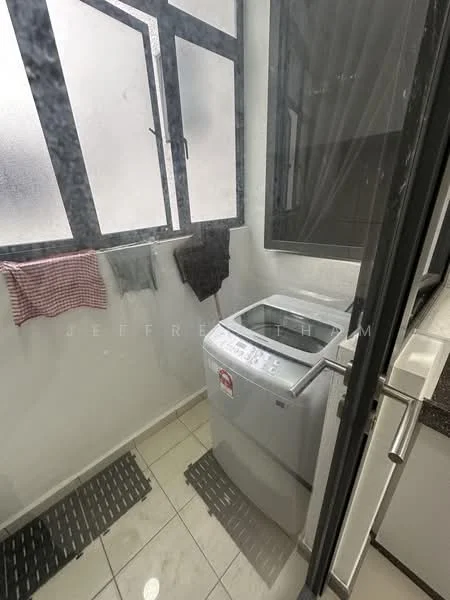 Laundry features: top-load washing machine, white walls, grey tiled flooring, window with frosted glass, hanging clothes on a line, black mat on the floor.