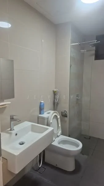 Bathroom features: white tiled walls, grey floor tiles, single-sink vanity with wall-mounted faucet, mirror above sink, one-piece toilet, walk-in shower with glass enclosure, chrome shower head, towel rack, soap dispenser, bottle of cleaning product; style: modern.