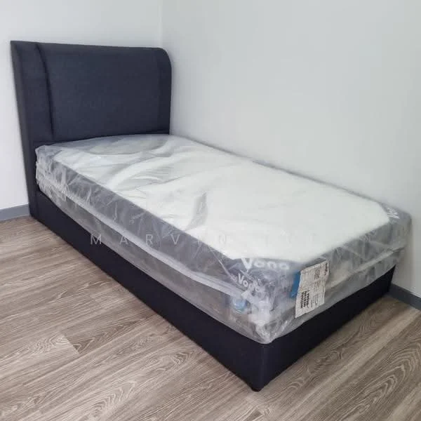 Bedroom features: single bed, upholstered headboard, mattress covered with plastic, laminate flooring, white painted walls; style: modern.