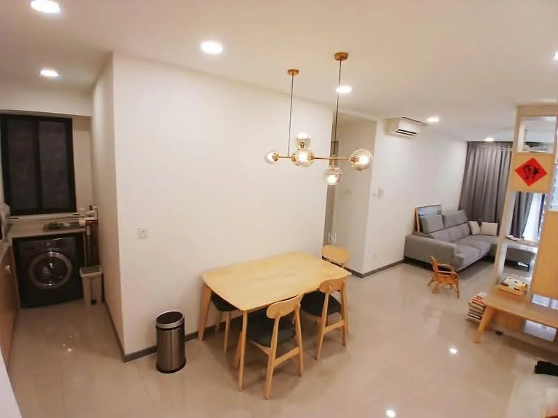 Dining features: round wooden dining table, 4 wooden dining chairs, pendant light fixture with multiple bulbs, grey tiled flooring, white painted walls, recessed ceiling lights, open layout to living area, bin, window with black frame; style: modern. Laundry features: front-load washing machine, wood cabinetry above washer, grey tiled flooring, white painted walls; style: modern. Living features: grey fabric sofa, coffee table, light grey curtains, wall-mounted air conditioning unit, bookshelf, grey tiled flooring, white painted walls, recessed ceiling lights; style: modern.