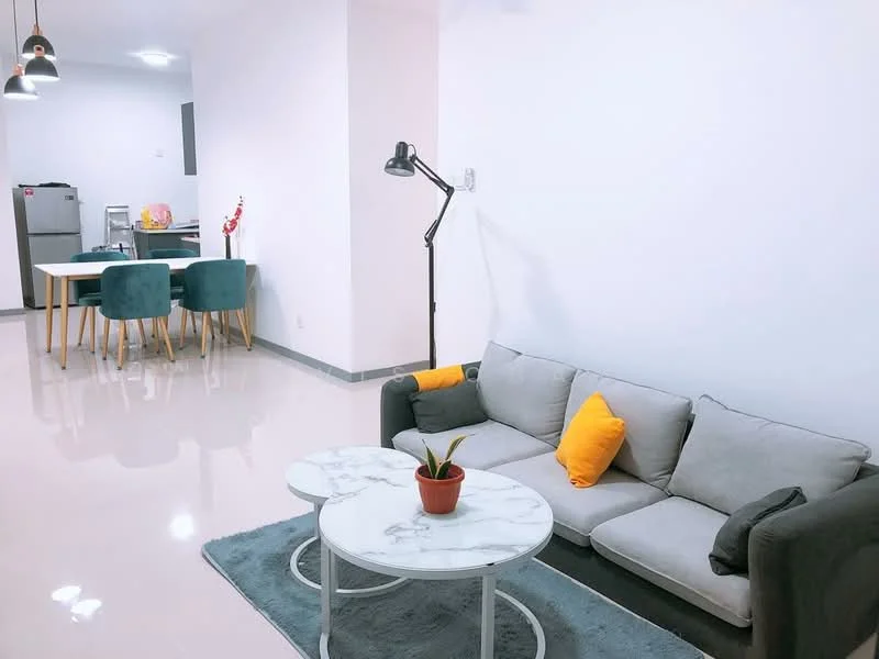 Living features: grey fabric sofa, yellow accent pillows, marble-top coffee table, area rug, floor lamp, recessed ceiling lights, glossy tile flooring, white painted walls; style: modern. Dining features: 6-seater dining table, upholstered dining chairs in teal, open kitchen view, refrigerator visible in background; style: modern.