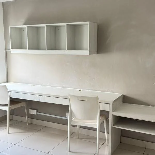 Study features: white desk with drawers, two white chairs, white wall-mounted shelving unit, light grey painted walls, glossy tiled flooring, natural light from window, minimalist design; style: modern.