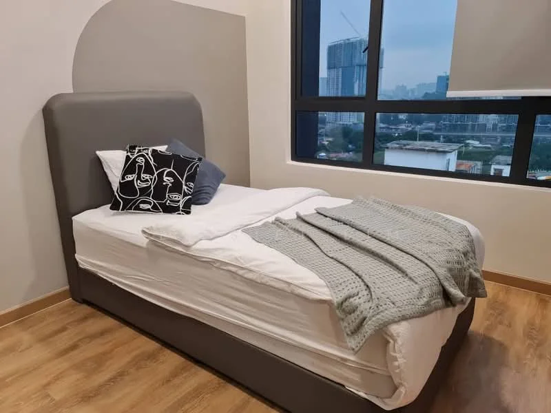 Bedroom features: single bed with grey upholstered headboard, white bedding with a grey throw blanket, decorative black and white pillow, wooden flooring, large window with city view, roller blinds, light-colored walls, nightstand with no visible features; style: modern; view: city.