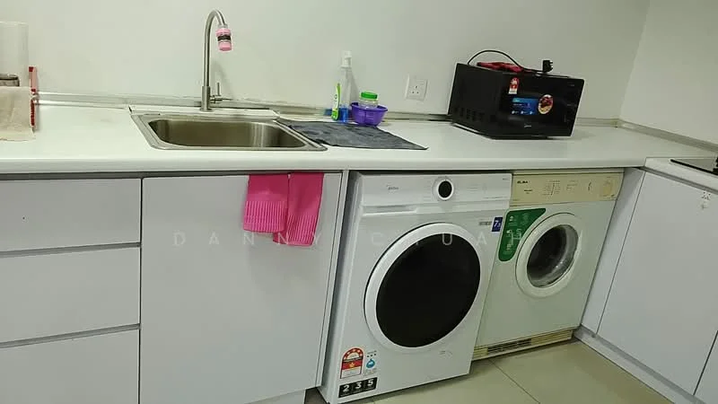 Laundry features: single-bowl stainless-steel sink, white cabinetry, white countertop, front-load washing machine, top-load washing machine, pink dish towel, black microwave, green and white detergent dispenser, grey mat, wall-mounted shelf; style: modern.