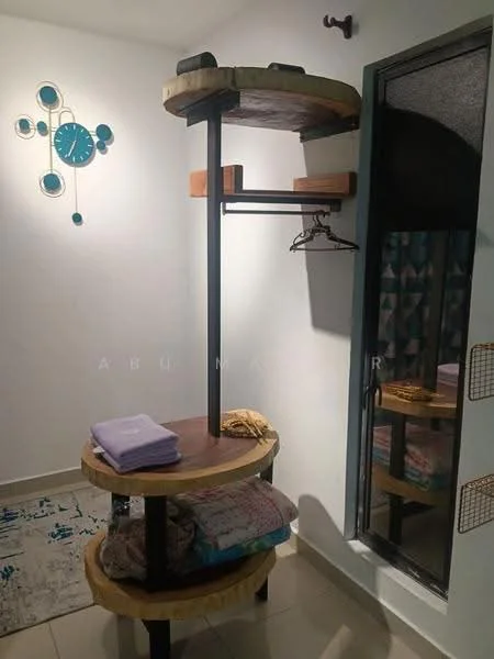 Room features: wall-mounted clock with blue accents, open shelving unit with circular top, wooden shelves, metal frame, hanging rod for clothes, stacked towels, decorative rug with geometric pattern, white painted walls, floor-to-ceiling window, curtains; style: modern.