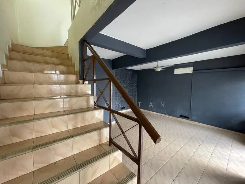 Room features: staircase with tiled steps, brown metal railing, grey accent wall, white ceiling, ceiling fan, tiled flooring in beige, open space layout, natural light from staircase area; style: modern.