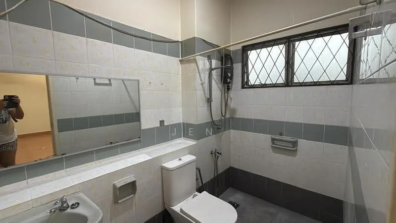 Bathroom features: white tiled walls with grey accents, grey tiled flooring, single-sink vanity with mirror, one-piece toilet, shower with glass enclosure, handheld shower, wall-mounted showerhead, window with security bars, towel rack.