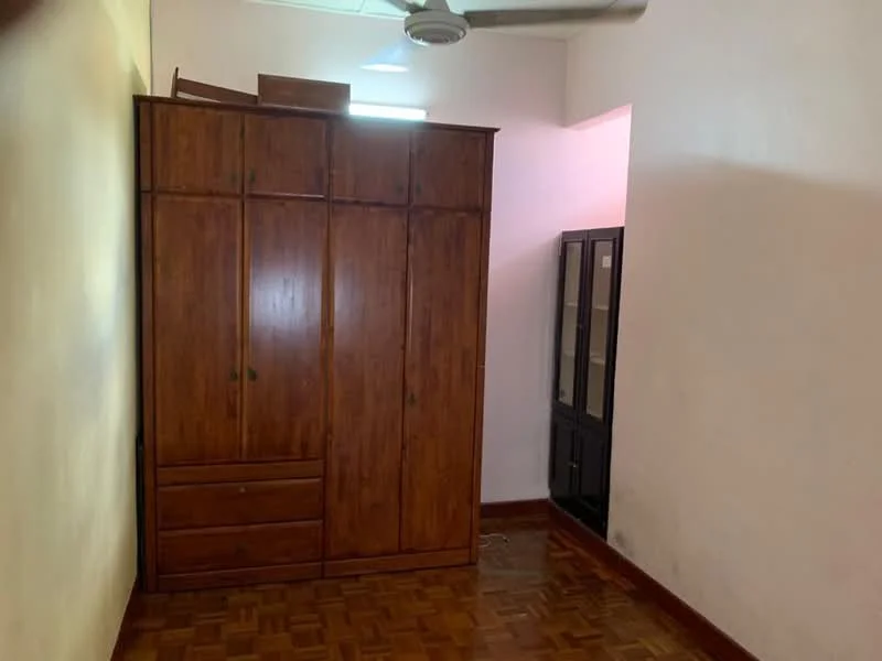Room features: wooden wardrobe with drawers, wooden shelving unit, parquet wood flooring, white painted walls, ceiling fan.
