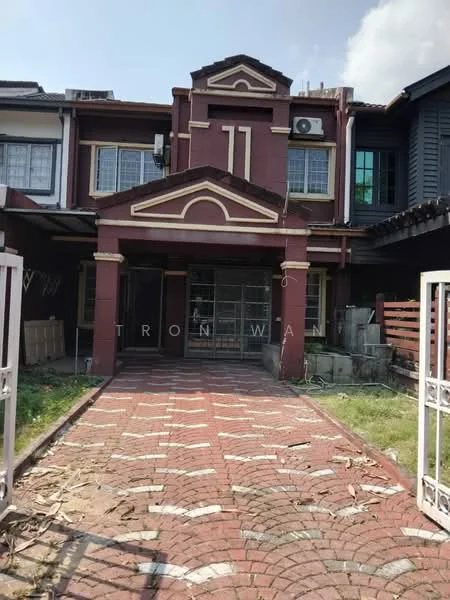 Exterior type: linked terrace house; features: red painted facade, brick driveway with decorative pattern, manicured lawn, front porch with columns, gated entrance, two-storey structure, visible air conditioning unit, window grilles, front garden area; style: traditional.