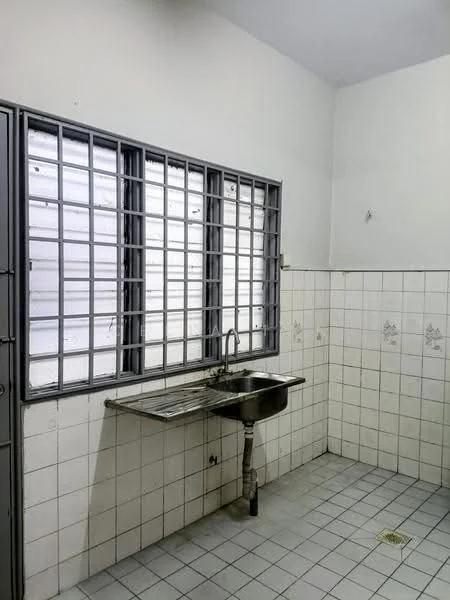 Kitchen features: single-bowl stainless-steel sink, chrome faucet, wall-mounted metal shelf, white tiled walls, grey tiled flooring, grilled window, white painted walls, corner layout.