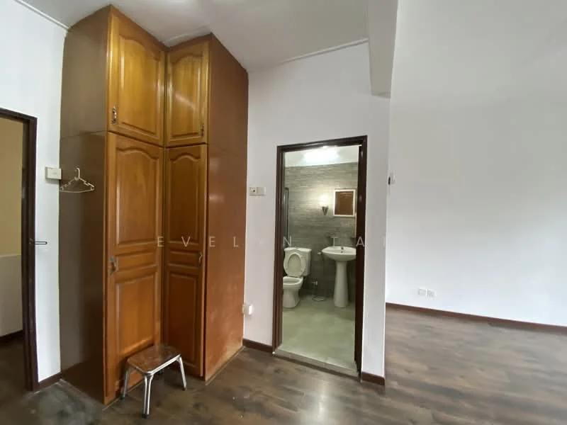 Room features: wooden cabinetry with brown finish, grey tiled flooring, white painted walls, doorway leading to bathroom, stool, light switch, door frame, visible plumbing fixtures; style: modern.