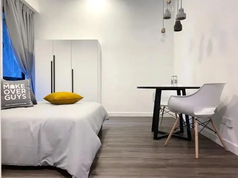 Bedroom features: queen-size bed with grey bedding, white bedside pillow, yellow decorative pillow, white wardrobe with sliding doors, black dining table, white chair, wooden flooring, curtains, hanging pendant lights, window with view, decorative throw pillow; style: modern.
