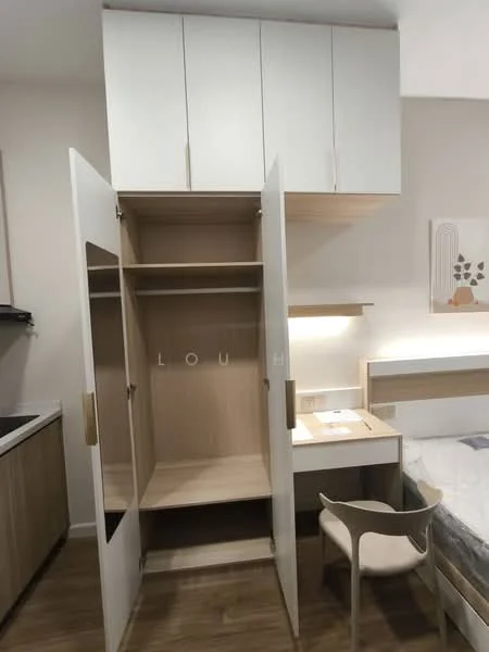 Room features: built-in wardrobe with sliding doors, light wood cabinetry, white upper cabinets, desk with lamp, chair, laminate flooring, neutral wall color, bed with bedding; style: modern.