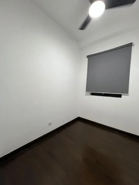 Room features: white painted walls, dark wood flooring, ceiling fan, roller blinds on window.