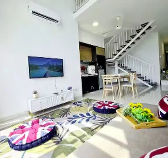 Living features: wall-mounted TV, white TV console, 5-blade ceiling fan, air conditioning unit, large windows, area rug with floral pattern, decorative cushions with Union Jack design, wooden dining table with chairs, staircase with white railing, potted flowers on tray, polished tile flooring, open layout to kitchen, natural light from windows; style: modern.