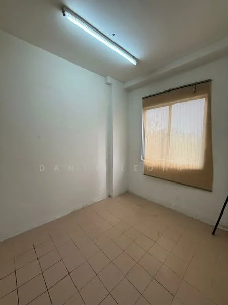 Room features: white painted walls, tile flooring, window with vertical blinds, fluorescent ceiling light, empty space.